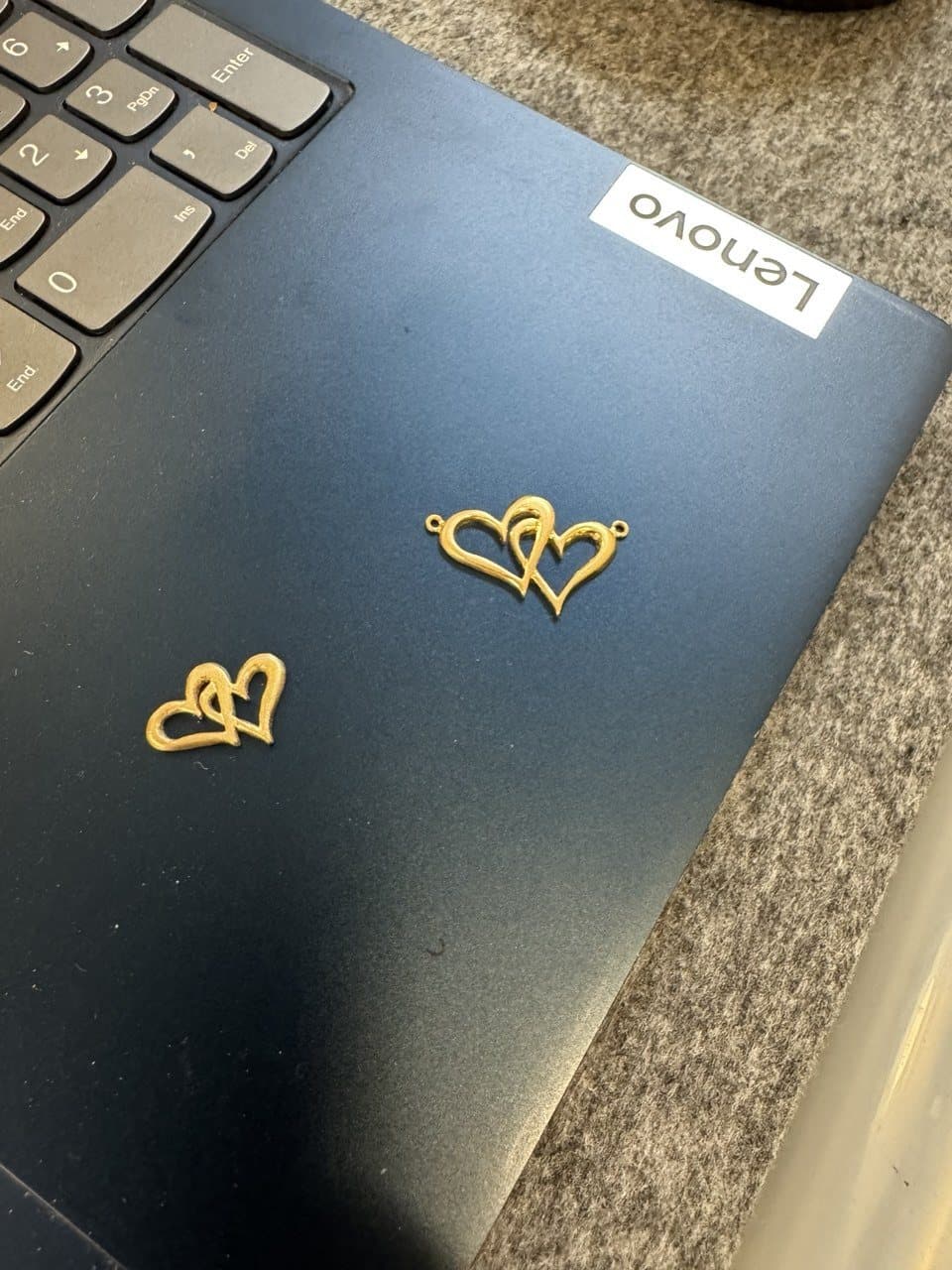 Two double hearts cut out in gold